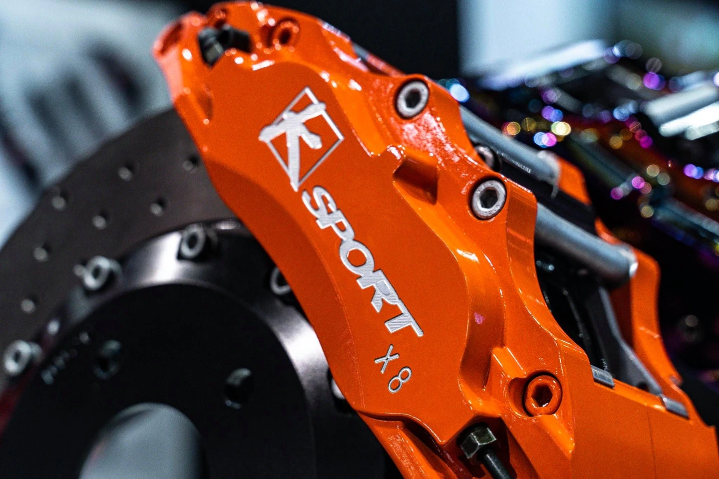 Genuine orange KSport brake caliper and rotor display at SEMA 2019