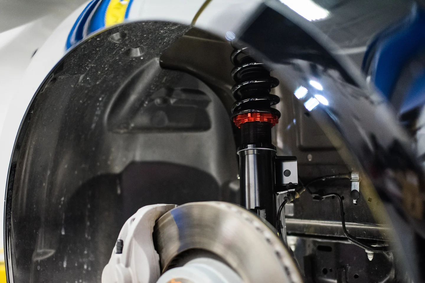 Documented KSport coilover installed in a vehicle wheel well